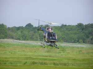 helicopter spraying close to field surface